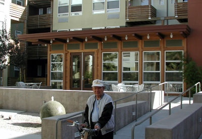 Man walking his bike at the courtyard of Mabuhay Court in San Jose, Ca.