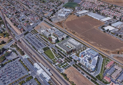 Aerial view showing the rendering of Windflower II to the north, the Union Flats next door, and Station Center Family Housing to the south in Union city