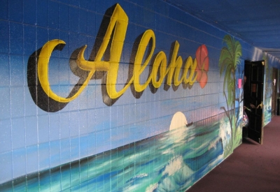 Mural with ocean water and the word "Aloha" written in cursive.