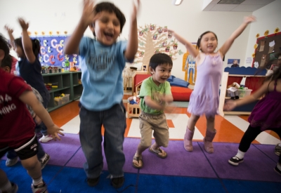 Children jumping in the classroom at Paseo Senter in San Jose, California.