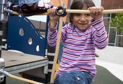 Child playing on the playground at Paseo Senter in San Jose, California.