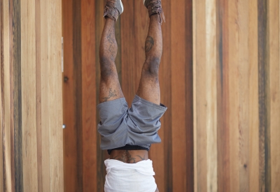 Resident doing handstand in the courtyard of Bayview Hill Gardens in San Francisco, Ca.