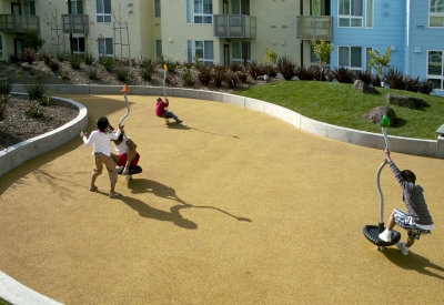 Kids playing at the play area in the resident courtyard at Ironhorse at Central Station in Oakland, California.