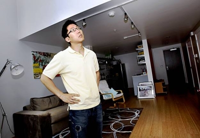 Resident standing in his living room at Pacific Cannery Lofts in Oakland, California.