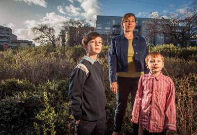 Resident and her two children standing with Coggins Square in Walnut Creek, California in the background.