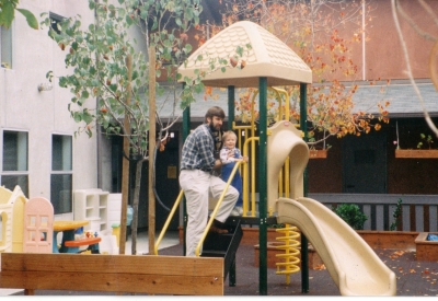 Man and child playing on the play structure at Sunrise Village in Fremont, California.