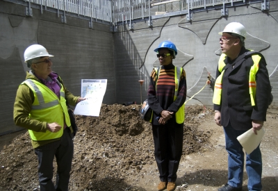 3 people with hard hats at the construction site of Armstrong Place Senior in San Francisco.