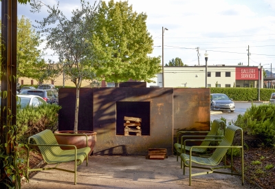Outdoor steel fireplace and chairs at Bettola Restaurant in Birmingham, Alabama.