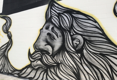 Detail of a piece of art of a man with a large beard on the side of David Baker Architects office in Oakland, California.