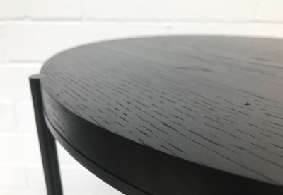 Detail of the black wood coffee table.