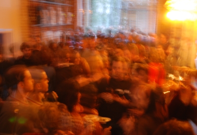 Blurry photo of a crowd during a party at David Baker Architects Office in San Francisco.