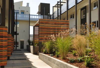 Courtyard with pergola seating areas at Armstrong Place in San Francisco.