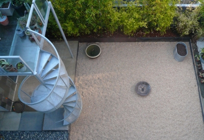 Looking down to the courtyard with the deck and spiral stairs in partial view at Shotwell Design Lab in San Francisco.