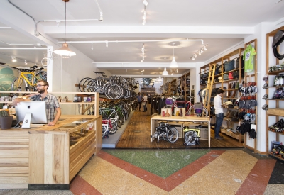 Interior view of the counter and hanging bicycles inside Huckleberry Bicycles in San Francisco.