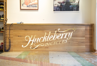 Wood fixture with Huckleberry Bicycle logo on it.