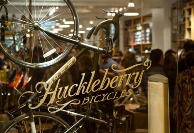 Exterior glass detail of the Huckleberry Bicycles logo.