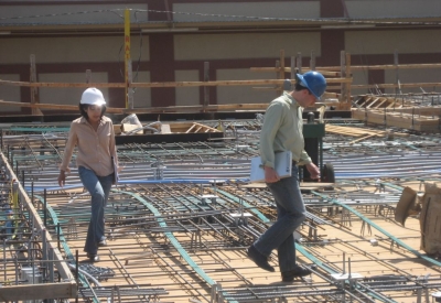 Man and woman wearing hard hats at the construction site at Armstrong Place Senior in San Francisco.