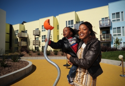 Woman holding a young boy at the grand opening of Ironhorse at Central Station in Oakland, California.