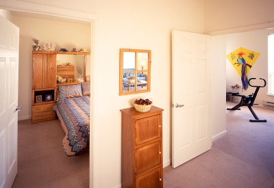 Interior view of unit bedroom and living room at Moonridge Village in Santa Cruz, California.