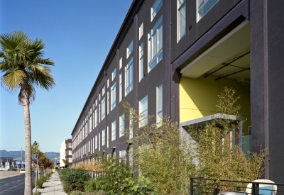 Exterior view of the west facing elevation with stoop entries at Pacific Cannery Lofts in Oakland, California.