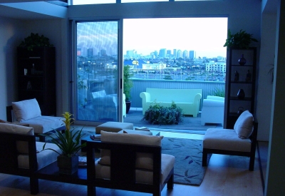 Interior view of a unit living room and balcony at 1500 Park Avenue Lofts in Emeryville, California.