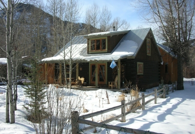 Exterior view of the Redstone Cabin covered in snow in Redstone Colorado.