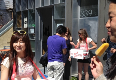 People standing outside StoreFrontLab selling popsicle art.