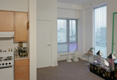 Interior of apartment unit with personal items arranged by resident. 