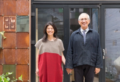 A woman and a man holding hands in front of Zero Cottage in San Francisco.