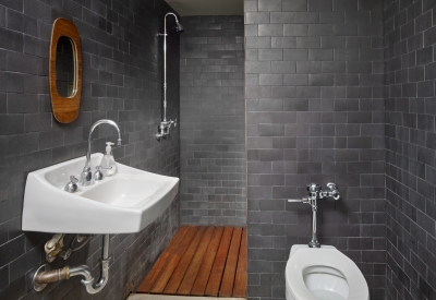 Bathroom covered in black tile inside Shotwell Garden Retreat in San Francisco.