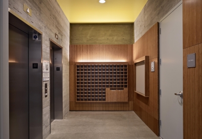 Custom plyboo mail cubbies in the elevator lobby of Richardson Apartments in San Francisco.