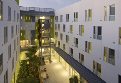 Dusk view of illuminated courtyard at Richardson Apartments in San Francisco.