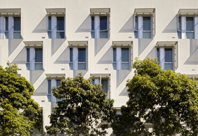 Detail of aluminum sunshades on white stucco bay at Richardson Apartments