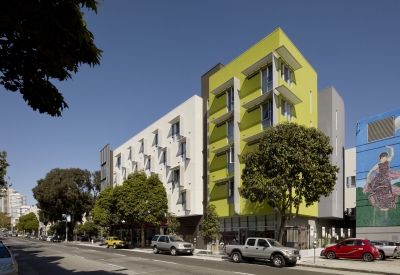 Wide view of southwest corner of Richardson Apartments, showing bright green and white stucco bays