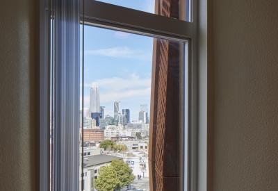 Looking out of a residents window at Tahanan Supportive Housing in San Francisco.