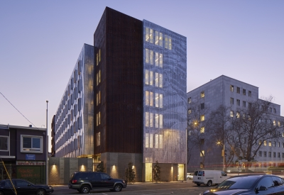 Exterior at dusk of Tahanan Supportive Housing in San Francisco.