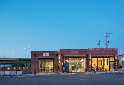 Exterior view of the bakery, barbershop, and café at dusk at the Bandsaw Building in Birmingham, Alabama.