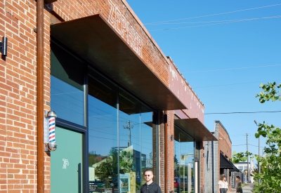 Exterior view of the barbershop and bakery from the sidewalk at the Bandsaw Building in Birmingham, Alabama.