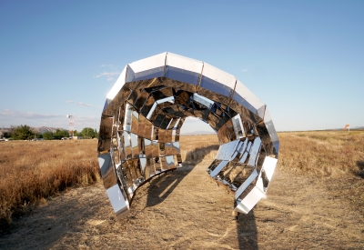 Looking through peepSHOW in the desert with mountains behind it in New Cuyama, California.