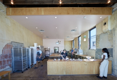 Interior of Last Call Bakery with someone standing a the counter at the Bandsaw Building in Birmingham, Alabama.