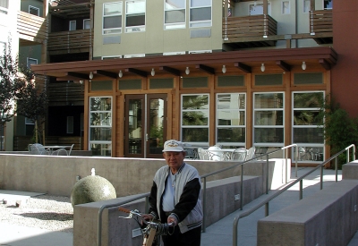 Man walking his bike at the courtyard of Mabuhay Court in San Jose, Ca.