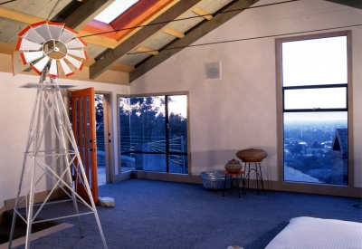 Main bedroom with door leading to the side door inside Revenge of the Stuccoids in Berkeley, California.