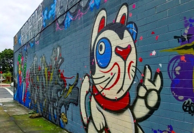 Detail of street art of a Japanese lucky cat on David Baker Architects office in Oakland.