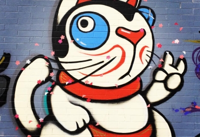 Detail of street art of a Japanese lucky cat on David Baker Architects office in Oakland.