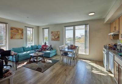 Unit living room inside Coliseum Place in Oakland, California.