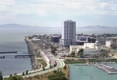Exterior view of Isle House on Treasure Island with the San Francisco bay in the background.