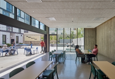 Community lounge opening out into the courtyard at 555 Larkin in San Francisco.