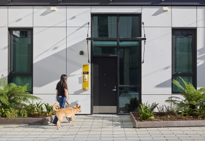 Woman walking her dog in the courtyard of 555 Larkin in San Francisco.