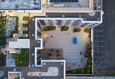 Aerial view of the courtyard and rooftop garden at 555 Larkin at dusk.