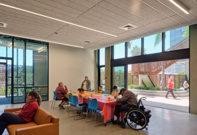 Community room flowing out to the courtyard at Sango Court.